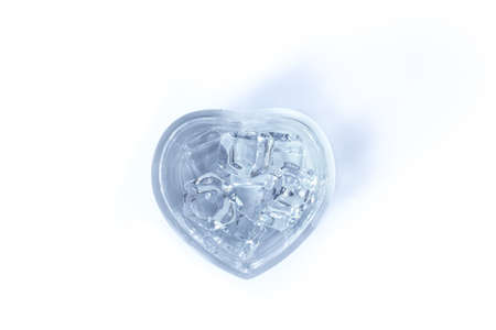 Water in glass heart on a white backgroundの写真素材