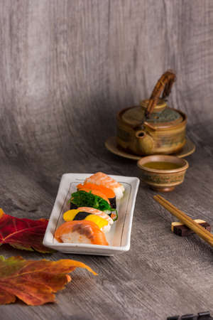 sushi  and tea drinking set on old wood backgroundの写真素材
