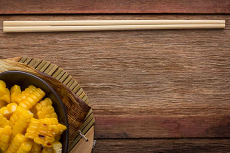 split corn on wood background, View from above with copy space.の写真素材
