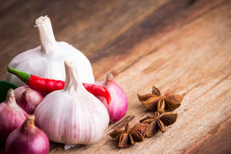 Vegetable on old wooden background(focus on spices)の写真素材