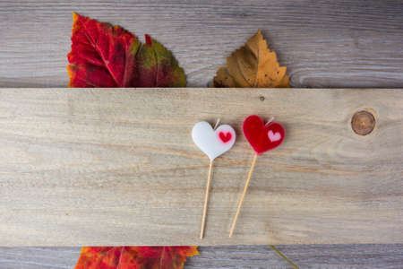 heart-shaped candle placed on wood.の写真素材