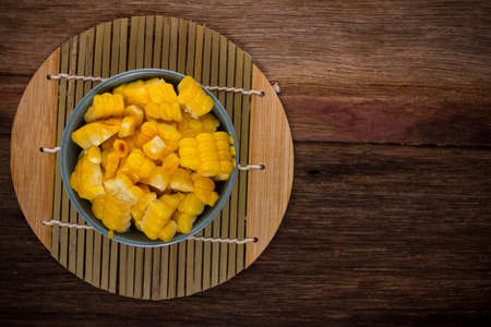 split corn on wood background, View from above with copy space.の写真素材