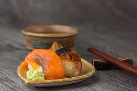 sushi  and tea drinking set on old wood backgroundの写真素材