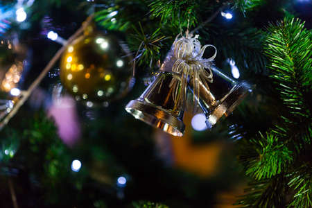 christmas tree and decorations on color bokeh background