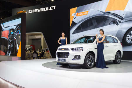 BANGKOK - December 11, 2015 : Unidentified model with Chevrolet Captiva car on display at the 32nd Thailand International Motor Expo 2015 on December 11, 2015 in Bangkok, Thailand.のeditorial素材