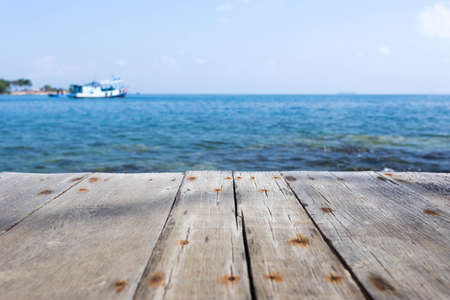 Close up with wooden walkway and view of sea and blue skyの写真素材
