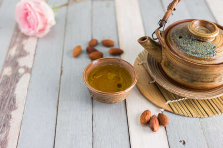 tea set and almon nut on old wood backgroundの写真素材