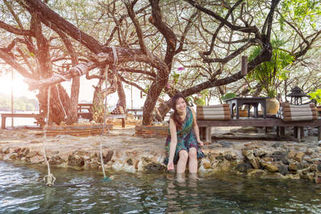 portrait of beautiful Asia woman wearing long dress on the beach and for people vacation in paradise destinationの写真素材