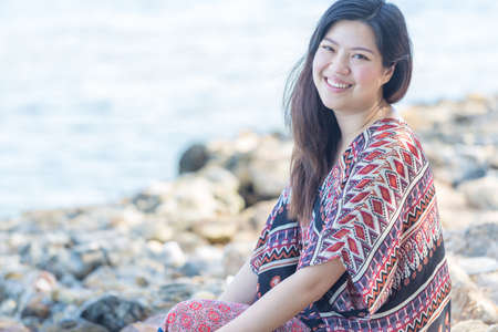 portrait of beautiful Asia woman wearing long dress on the beach and for people vacation in paradise destinationの写真素材