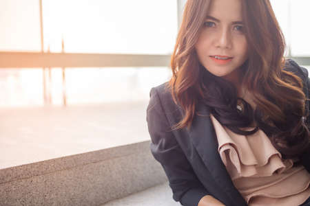 Beautiful Asia business woman over blue office background.の写真素材