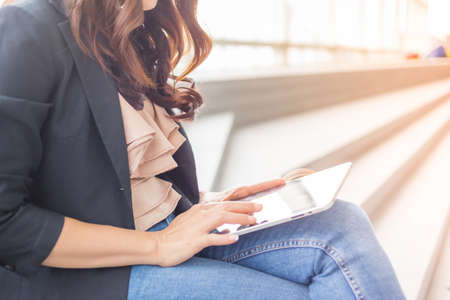 Beautiful Asia business woman over blue office background.の写真素材