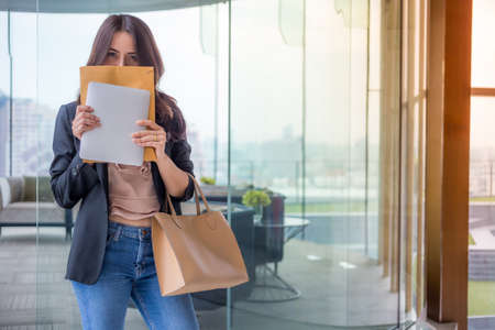Beautiful Asia business woman over blue office background.の写真素材