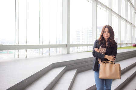Beautiful Asia business woman over blue office background.の写真素材