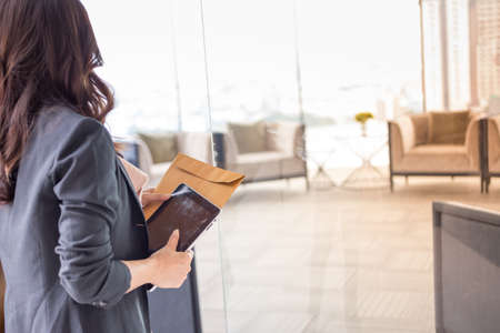 Beautiful Asia business woman over blue office background.の写真素材