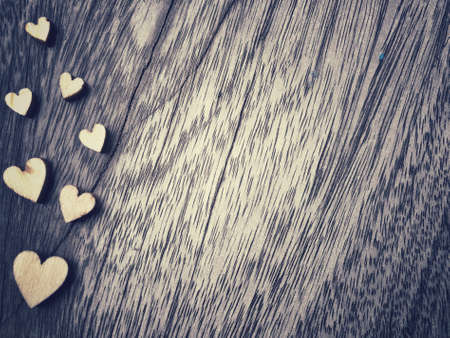 hearts shape on old wood table background, Valentine concept retro styleの写真素材