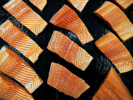 salmon fillet in front of black  background