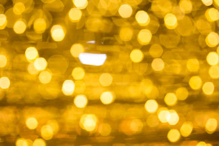Christmas light  on gold abstract lights bokeh backgroundの写真素材