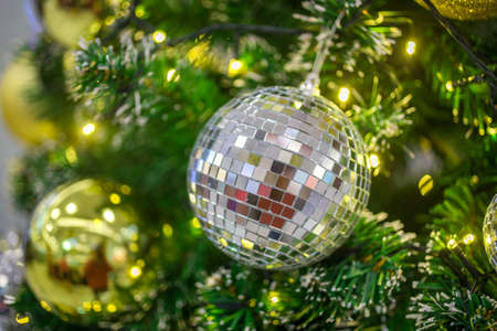 Christmas ball hanging on abstract lights backgroundの写真素材