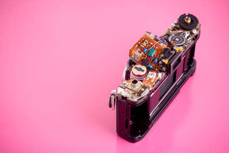 The old film camera washes out the parts on pink background.の写真素材