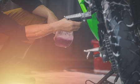 Motorcycle clean service. Employees are washing motorbikes.