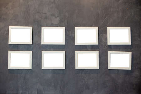 Collection of picture frames for paintings or photographs on the wall. Picture frames on Cement wall.の写真素材