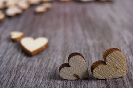 heart shaped wooden plate on vintage wood table.