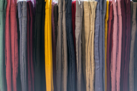 Clothes that are arranged on shelves and hangers.の写真素材