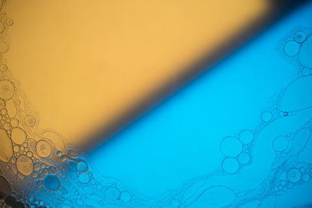 Top view movement of oil bubbles in the liquid. Oil surface multicolored background. Fantastic structure of colorful bubbles. Colorful artistic image of oil drop floating on the waterの写真素材
