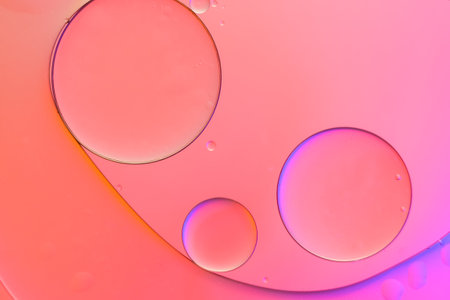 Top view movement of oil bubbles in the liquid. Oil surface multicolored background. Fantastic structure of colorful bubbles. Colorful artistic image of oil drop floating on the waterの写真素材