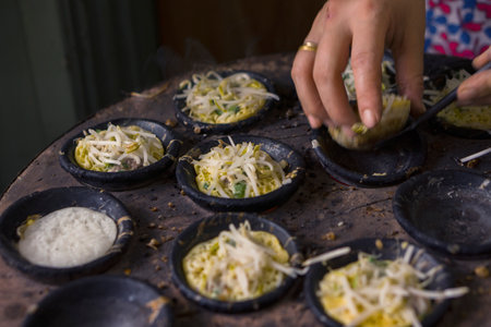 Vietnamese egg cake in a frying pan on the table in the restaurantの写真素材