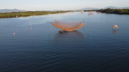 Fishing nets on the lake in the countryside of Hoi an, Vietnam.の写真素材