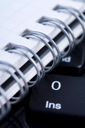 Black keyboard and notebook close upの写真素材