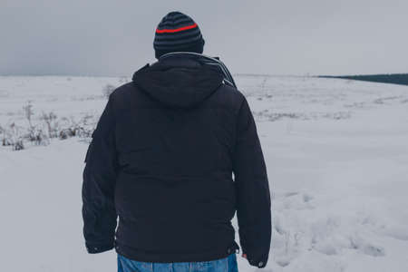 Male Traveler walking in the winter steppeの写真素材