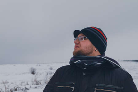 Male Traveler walking in the winter steppeの写真素材