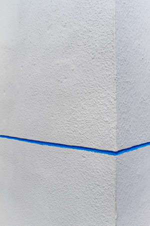 textured white walls with blue stripes in the villageの写真素材