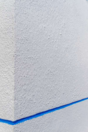 textured white walls with blue stripes in the villageの写真素材