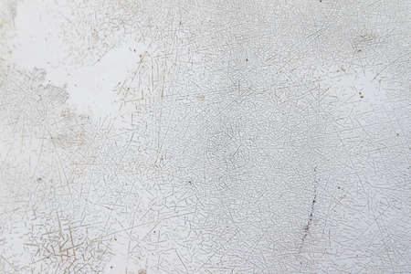 Close-up detail of cracked paint on rusty metal wall.