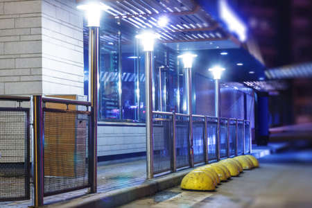 The night lights along the road and the entrance to the cafe