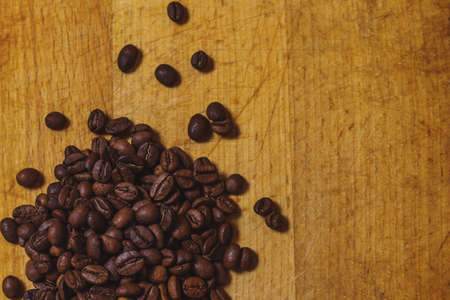 the coffee beans on old table for backgroundの写真素材
