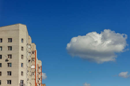 View from below of a high-rise buildings with contemporary architecture in business center in day. Tall modern skyscrapers against grey sky in big cityの写真素材