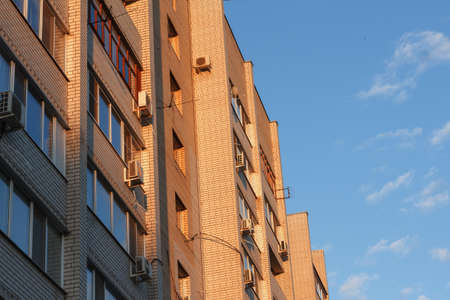 View from below of a high-rise buildings with contemporary architecture in business center in day. Tall modern skyscrapers against grey sky in big cityの写真素材