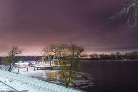 The ship is encased in ice on the bank of the river with a long exposureの写真素材