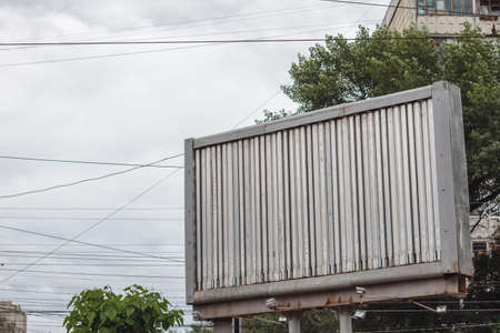 Blank billboard against blue sky.