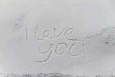 writing text LOVE YOU on the snow