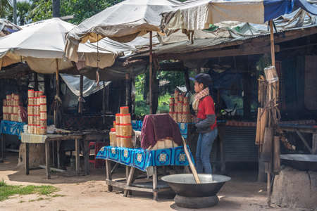 ANGKOR, CAMBODIA - OCTOBER 19, 2016: Woman are cooking on the streetのeditorial素材