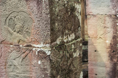 Khmer classical dancers shown in stone - An Apsara (also spelled as Apsarasa) in Banteay Kdei temple in Angkor, Siem Reap, Cambodia.の写真素材