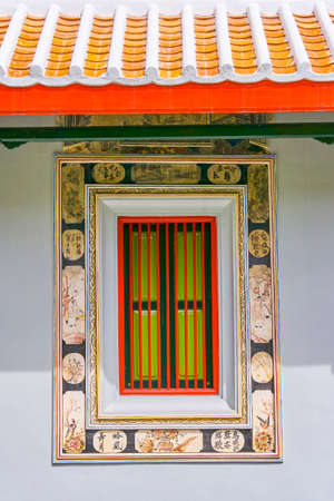 A Chinese style window with tile roofの写真素材