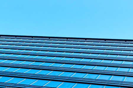 Modern office building with facade of glassの写真素材