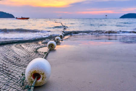 Fisherman's net view in the ocean at sunsetの写真素材