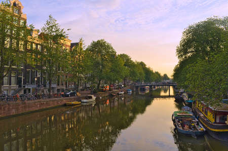 AMSTERDAM, NETHERLANDS, AUGUST 13, 2013: view of the typical water channel in the biggest dutch city...